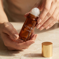 NOVORA Ritual Roller — Hands holding bottle